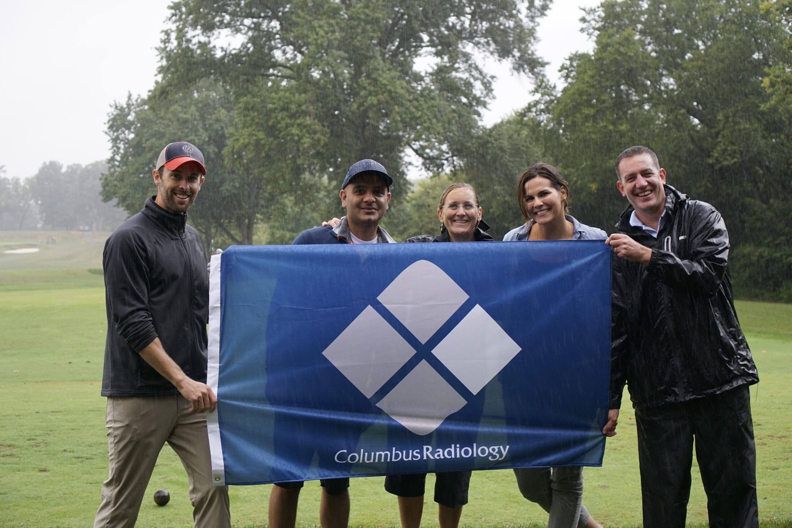 CRC staff holding a columbus radiology flag